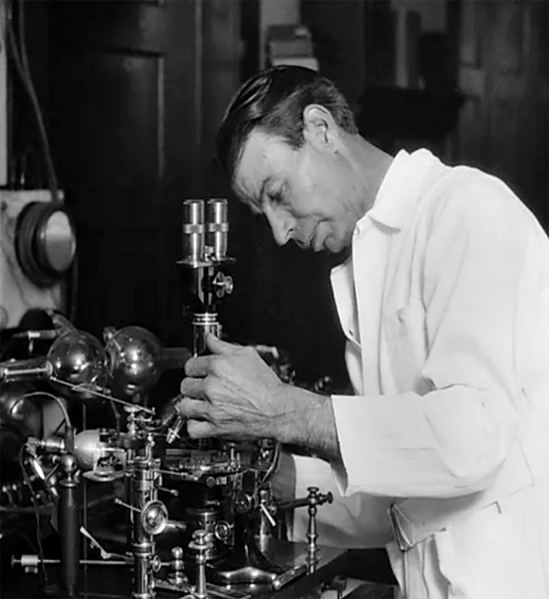 Dr. Royal Raymond Rife in his laboratory with his microscope and plasma frequency device, November 1929